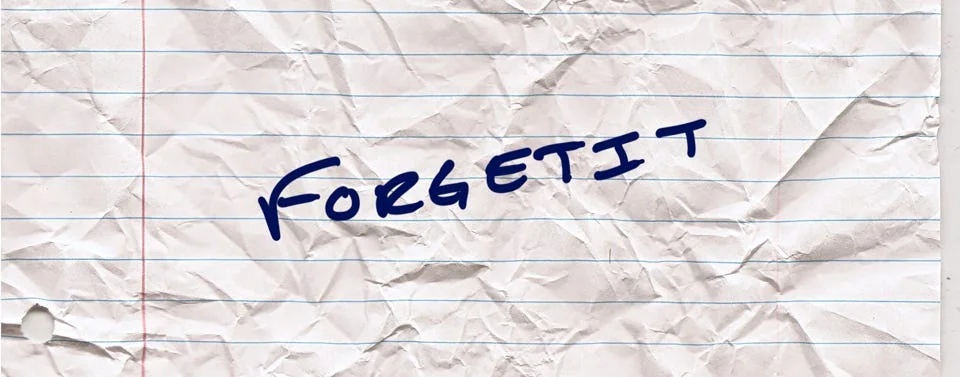 The same handwritten note on crumpled lined paper, now reading FORGETIT in blue marker.